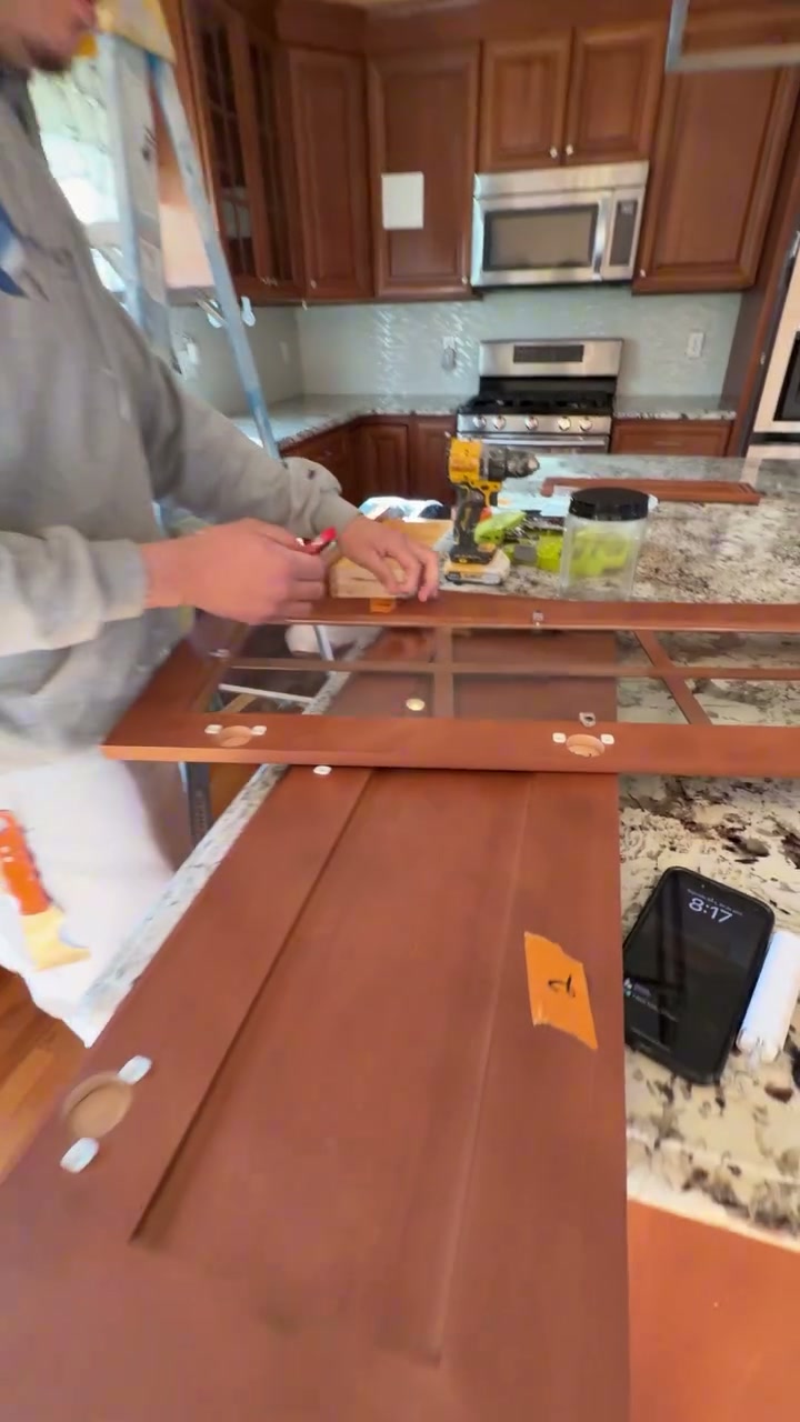 Pedretti's Cabinet Co. team member spraying a cabinet door