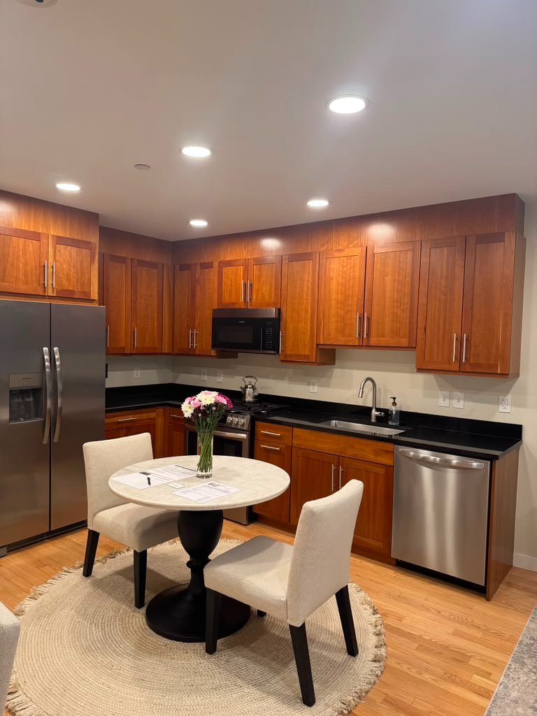 Kitchen with the original wood cabinets before painting