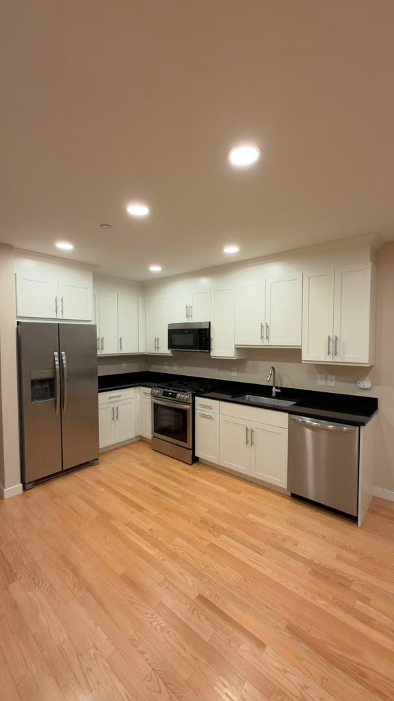 The same kitchen after Pedretti's Cabinet Co. painted the existing cabinets in a clean white finish